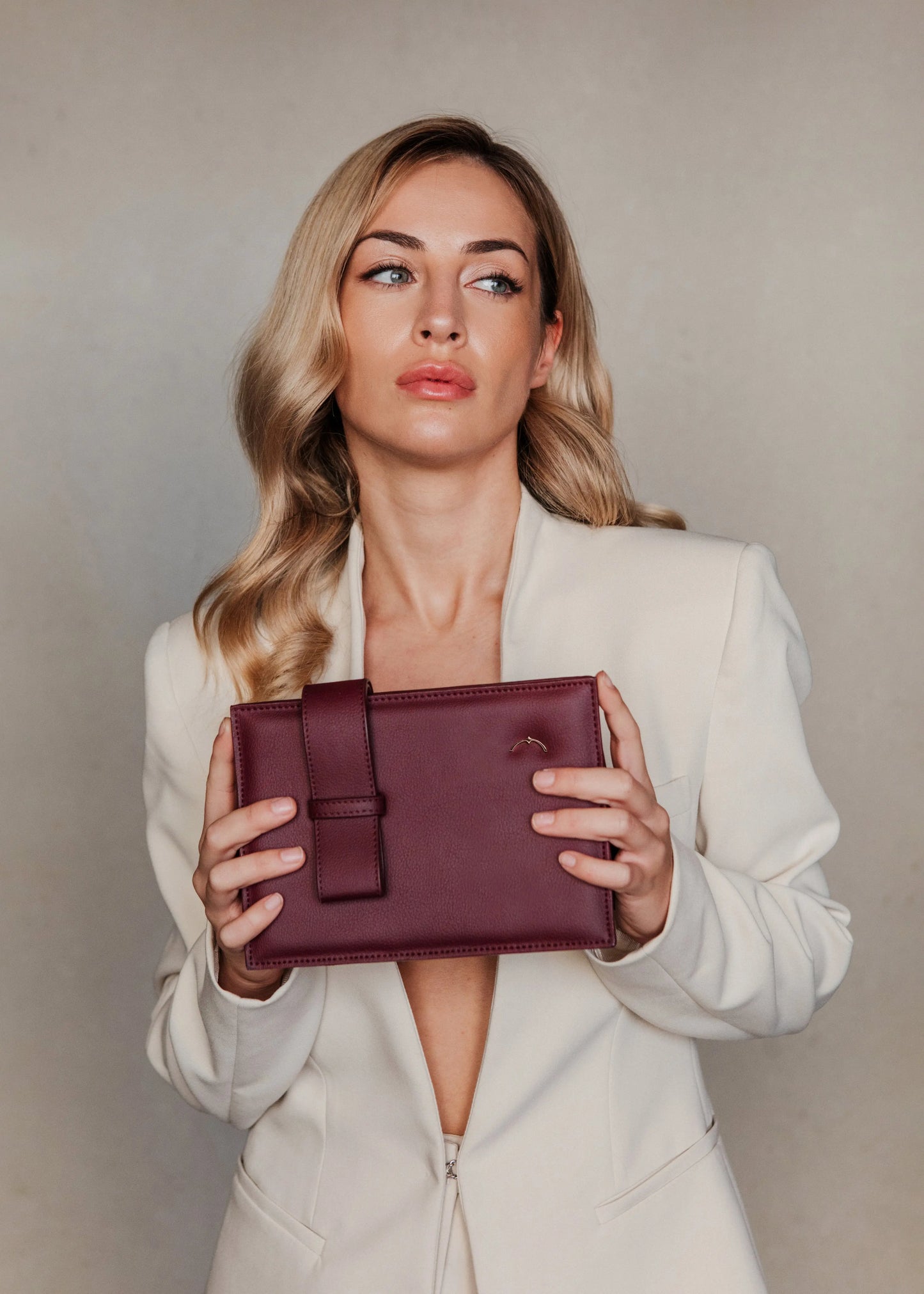 Model with coat and Qosmic Elara Nebula - burgundy handbag -