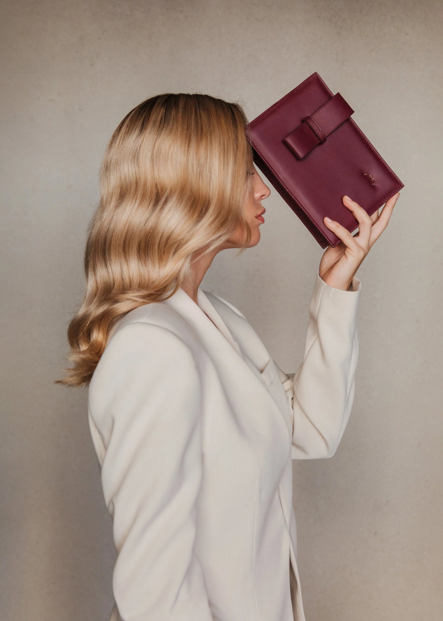 Model with coat and Qosmic Elara Nebula - burgundy handbag -