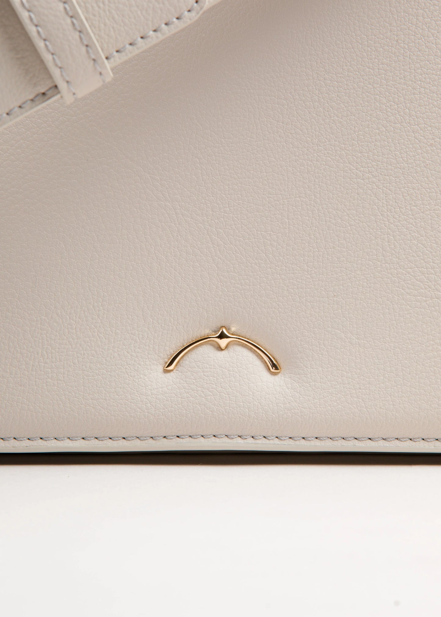 Qosmic Oberon Moonstone - cream bag - symbol detail