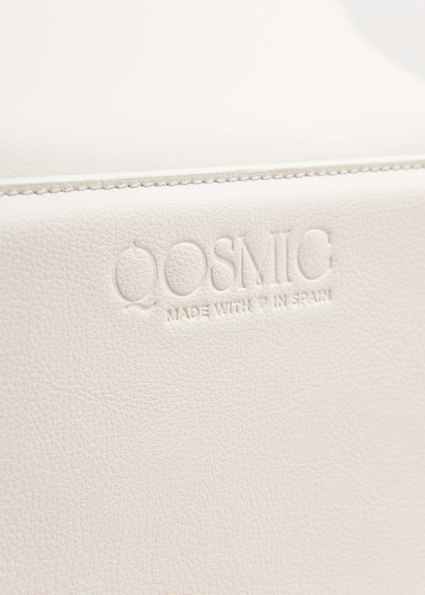 Qosmic Oberon Moonstone - cream bag - logo detail